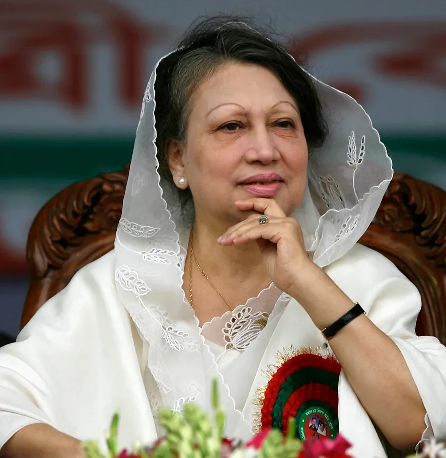 Khaleda Zia, former Prime Minister of Bangladesh, seated with quiet resolve as the Mother of Democracy banner